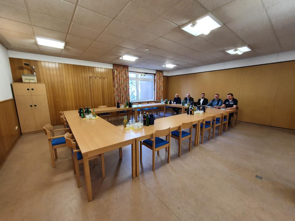 Fünf Vertreter von Verdi sitzen an einem Tisch. Sie sind alleine. Die restlichen Stühle sind leer.